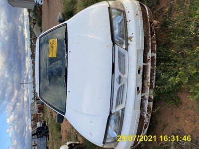 Impounded Vehicle: White Nissan Registration: 1CVG798